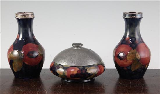 A pair of William Moorcroft Pomegranate pattern small vases, vases 14cm, bowl 20cm diameter